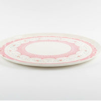 Side view of a flat cherry cake plate showing sturdy paper construction
