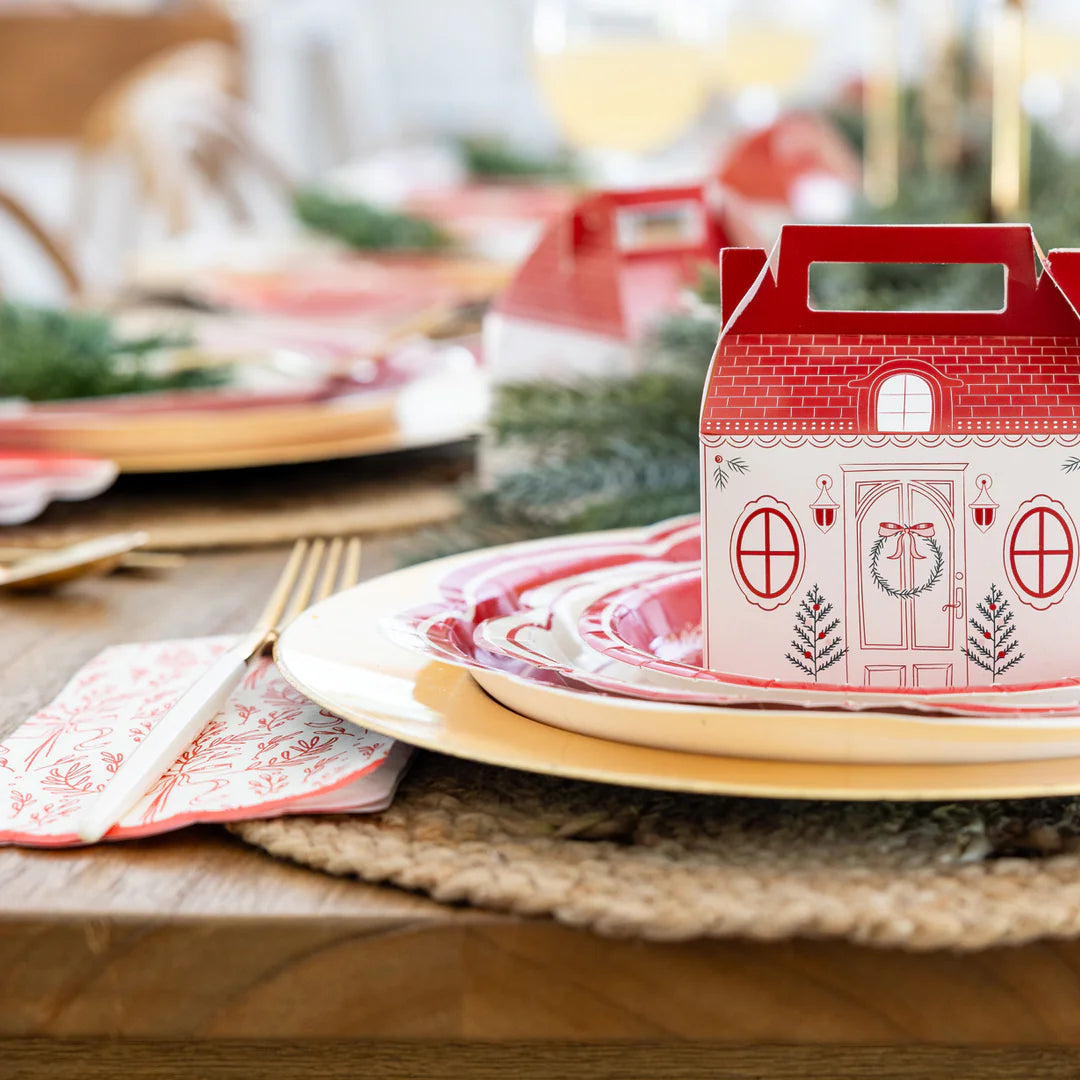 Close-up of the red bough Christmas napkins used with layered red plates and the cottage treat box.
