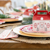 Close-up of the red bough Christmas napkins used with layered red plates and the cottage treat box.