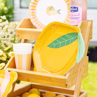 Lemon themed party table with striped cups and yellow decor