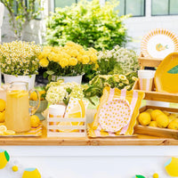 Lemon party table with square striped plates and flowers