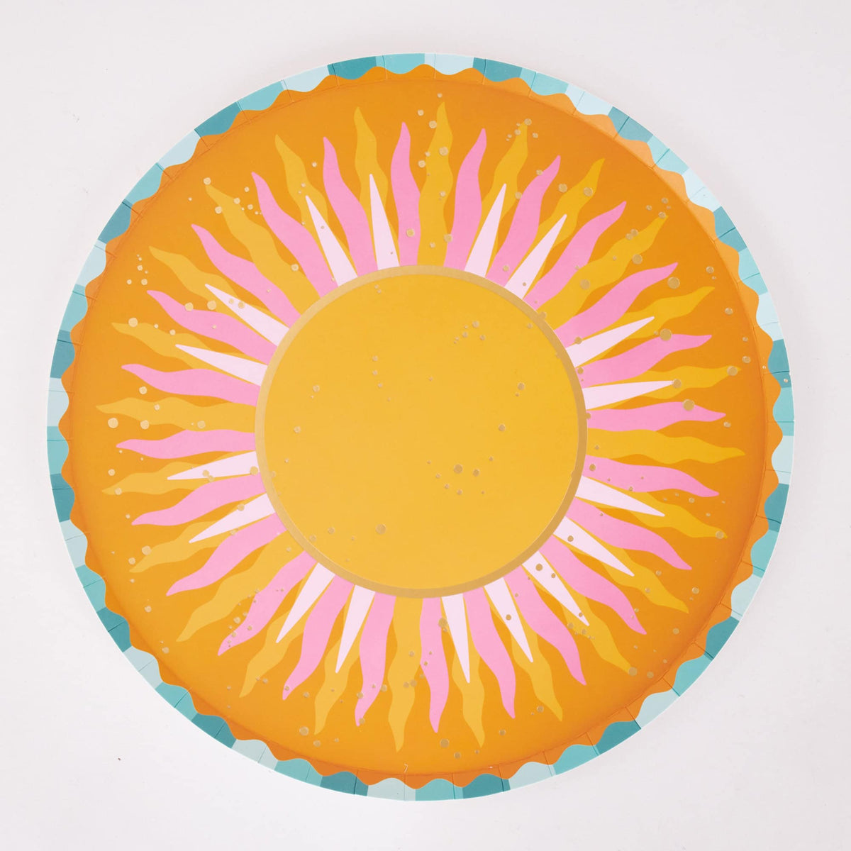 Single orange sunburst paper dinner plate with a golden center, pink rays, gold flecks, and a teal scalloped rim.