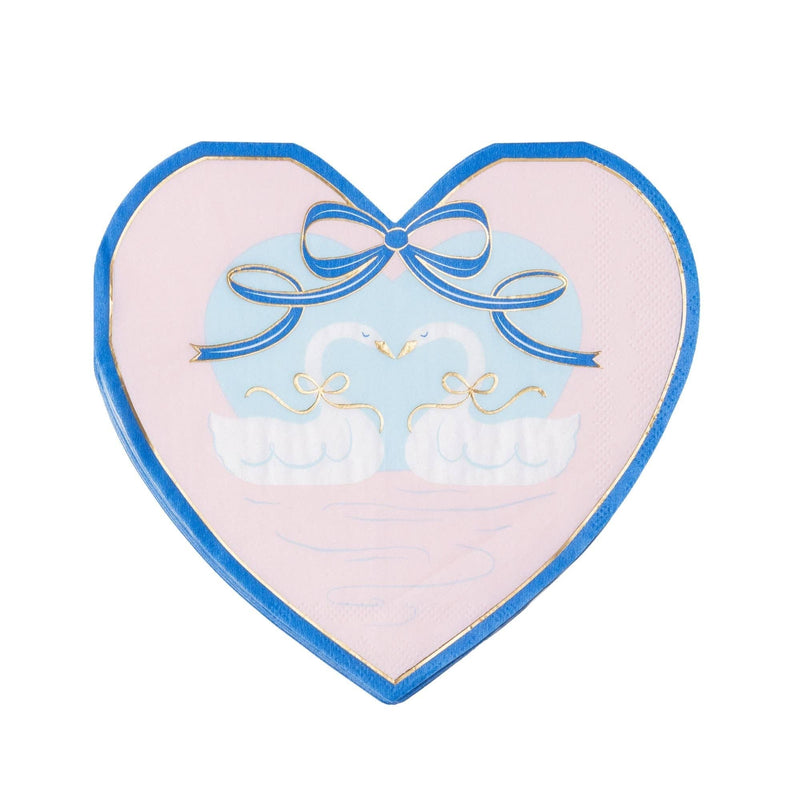 Heart shaped paper napkin with two white swans under a blue bow, pink ground with cobalt border and gold foil detail