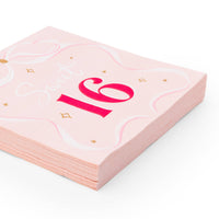 Stack of 3-ply petal pink napkins featuring a large red '16' and a hand-drawn white ribbon bow design.