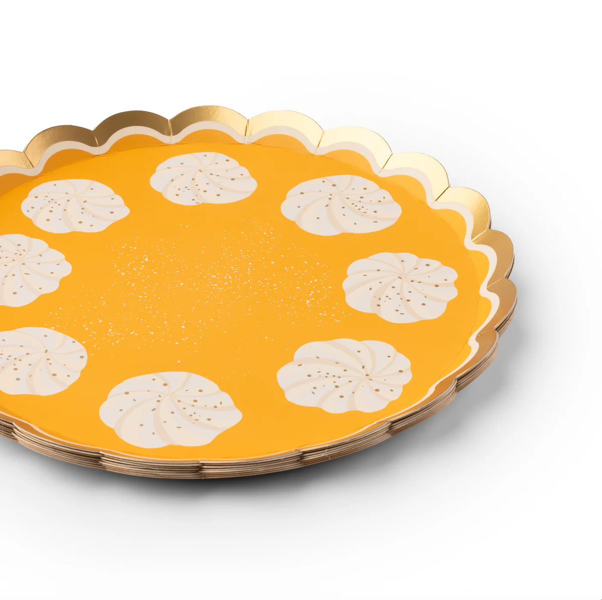 Side angle of the scalloped dessert plate highlighting the metallic gold rim and whipped-cream motif.