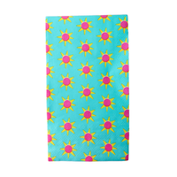 turquoise fiesta guest napkin with yellow sun pattern and pink centers
