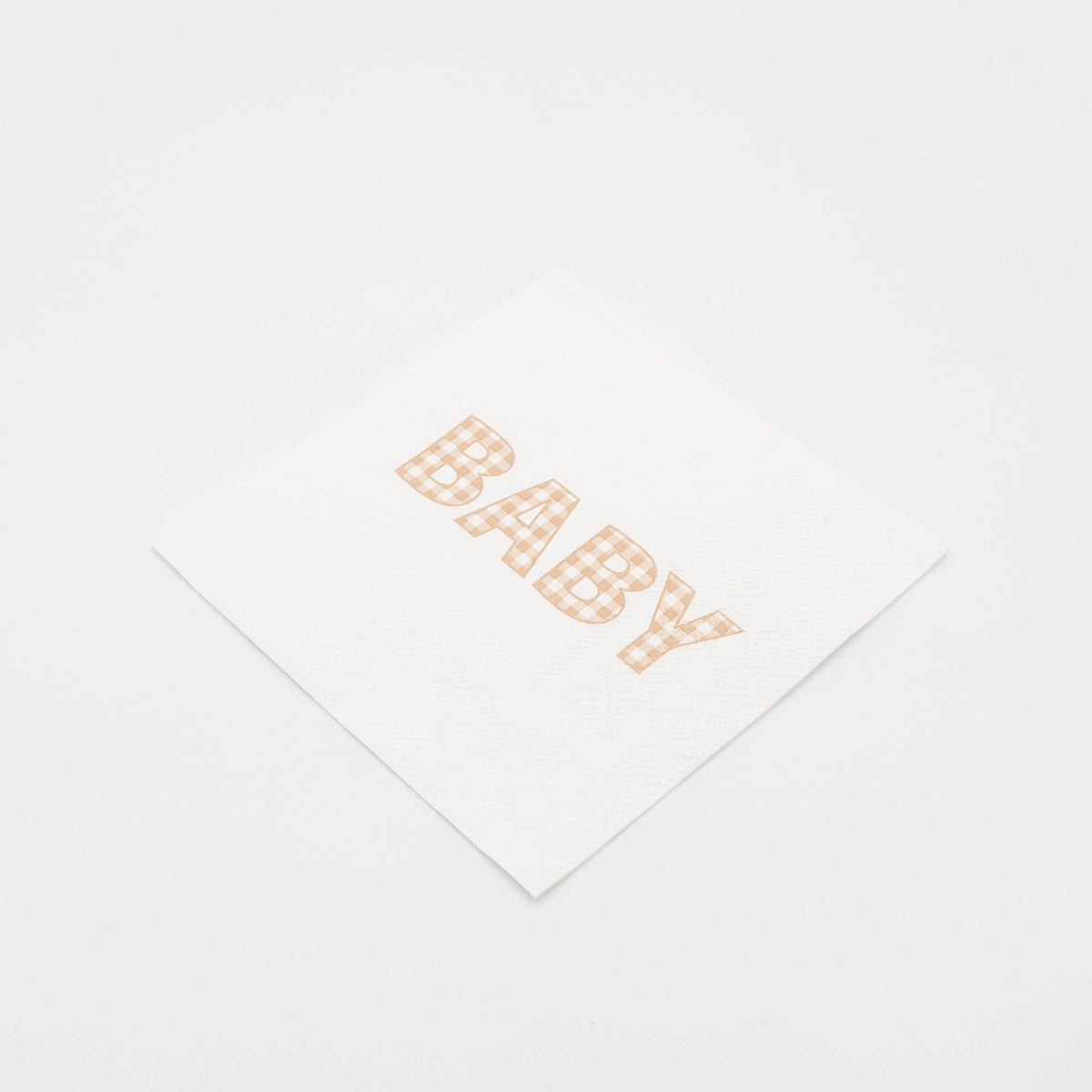 Tan gingham BABY paper cocktail napkin at an angle on white, showing the square folded size
