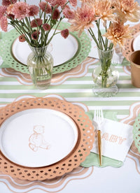 Tan gingham BABY napkin on a neutral baby shower table with peach and rose chrysanthemums in glass vases