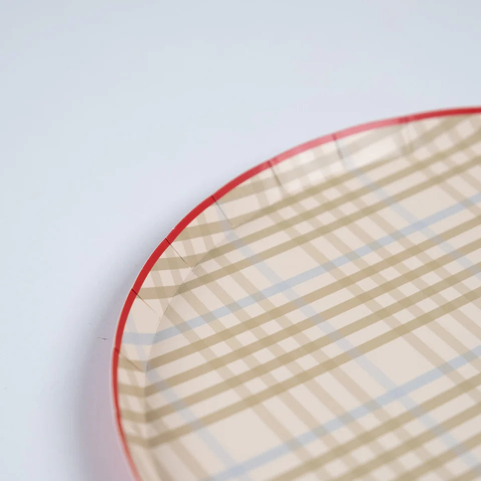 Close-up of a tan plaid paper dinner plate showing the khaki check pattern and red rim edge.