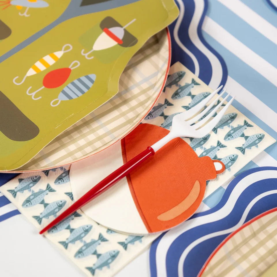 Tan plaid plate under a fishing vest plate with a fish napkin and red-handled fork.