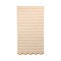 Tan striped dinner napkin with scalloped edge on white background