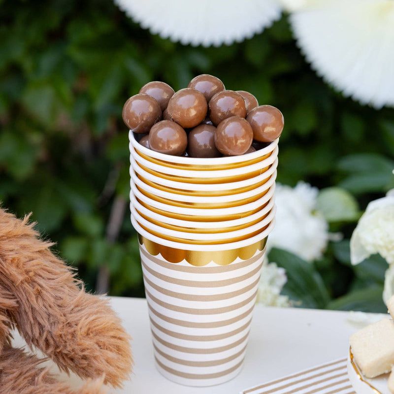 Stack of tan striped paper cups filled with chocolate treats
