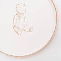 Close crop of the tan sketched teddy bear and scalloped tan rim on a cream paper plate