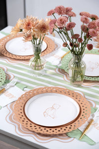 Neutral baby shower table with tan teddy bear plates, peach and rose mums in glass vases