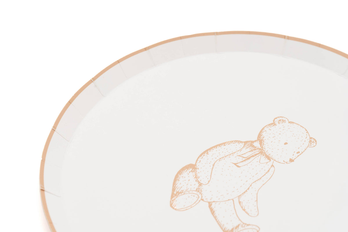 Close crop of the tan rim and sketched bear on a cream paper dessert plate