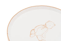 Close crop of the tan rim and sketched bear on a cream paper dessert plate