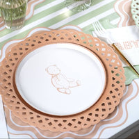 Tan teddy bear paper plate on a tan lattice charger with a sage scalloped napkin and green striped runner