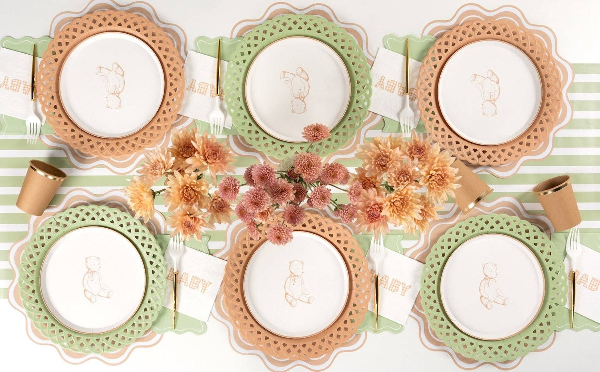 Overhead neutral tablescape with tan teddy bear plates on sage green and tan chargers and autumn mums