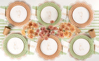 Overhead neutral tablescape with tan teddy bear plates on sage green and tan chargers and autumn mums