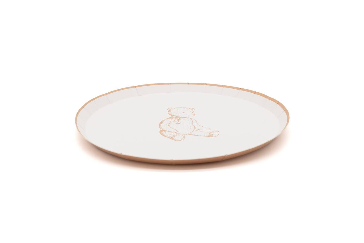 Side view of a tan teddy bear paper dessert plate showing the shallow rim profile