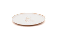 Side view of a tan teddy bear paper dessert plate showing the shallow rim profile