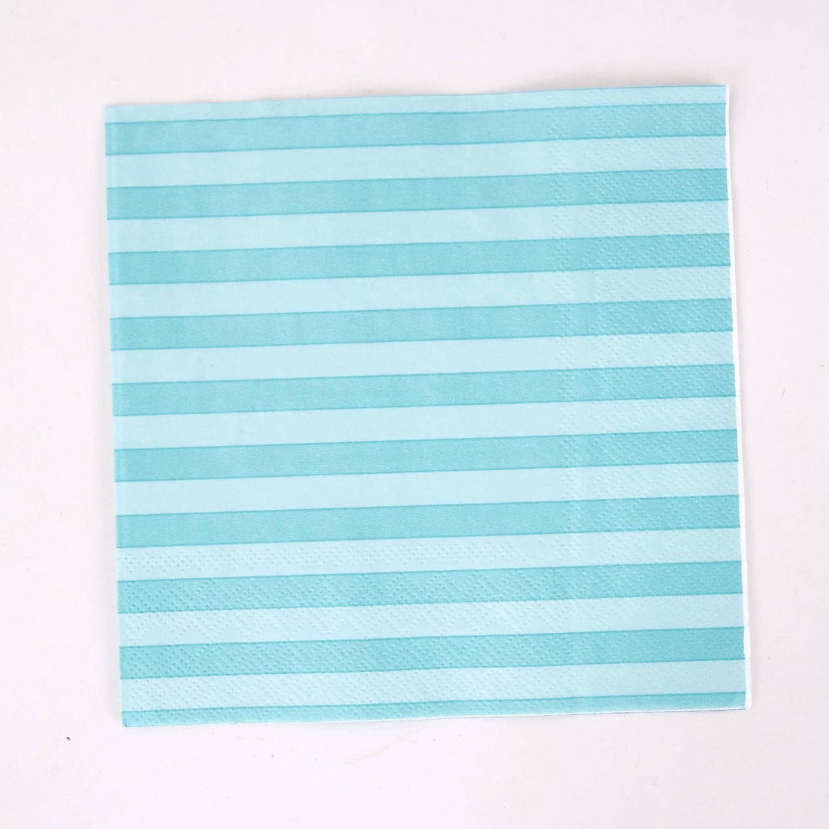 Single teal cabana stripe paper lunch napkin flat on white