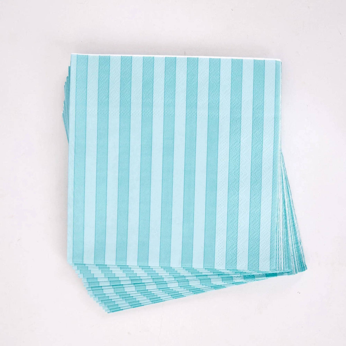 Stack of folded teal striped paper lunch napkins