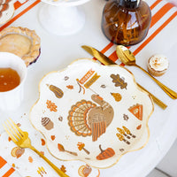 Close-up tablescape featuring icons plate with “Gobble” banner turkey artwork.