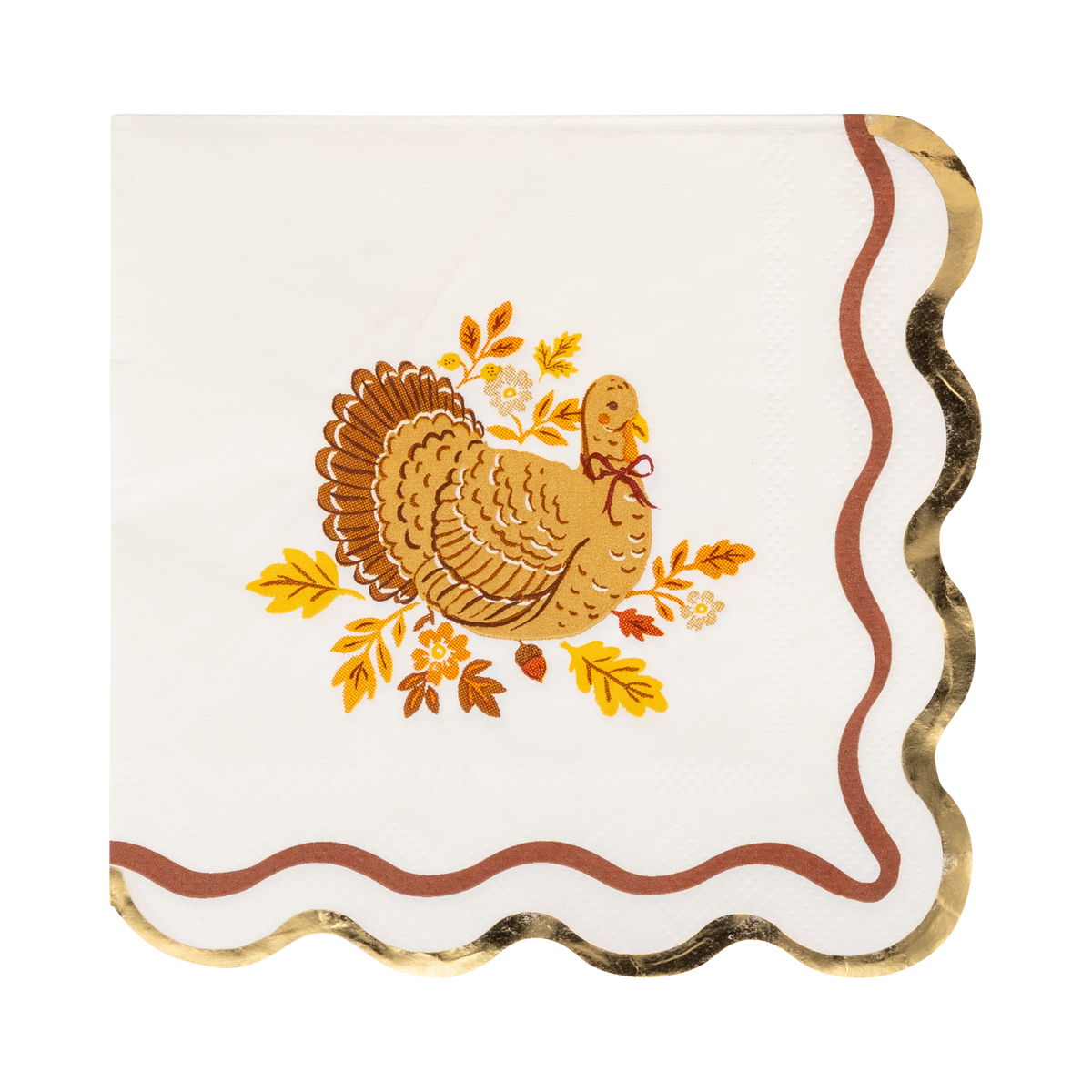 Cream Thanksgiving cocktail napkin with a detailed brown turkey illustration surrounded by fall leaves and acorns, gold foil wavy accent, and wavy orange edges, overhead flat-lay on gray background.