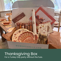 Thanksgiving Box: For a Turkey Day party without the fuss. Open Thanksgiving Subscription Box from Moment & Co, featuring turkey shaped plates, turkey party crackers, gold plastic cutlery, table runner, banner, napkins, and more.