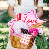 closeup of cherry paper plates inside picnic basket
