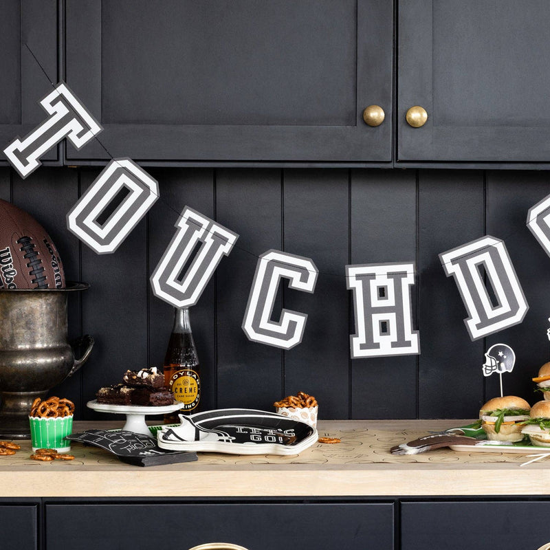 Touchdown banner displayed above football themed party table with snacks