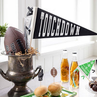 Touchdown felt pennant displayed on table for football game day party setup
