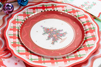 Overhead of tree plate on a plaid dinner plate with pink peonies and multicolor ornaments.