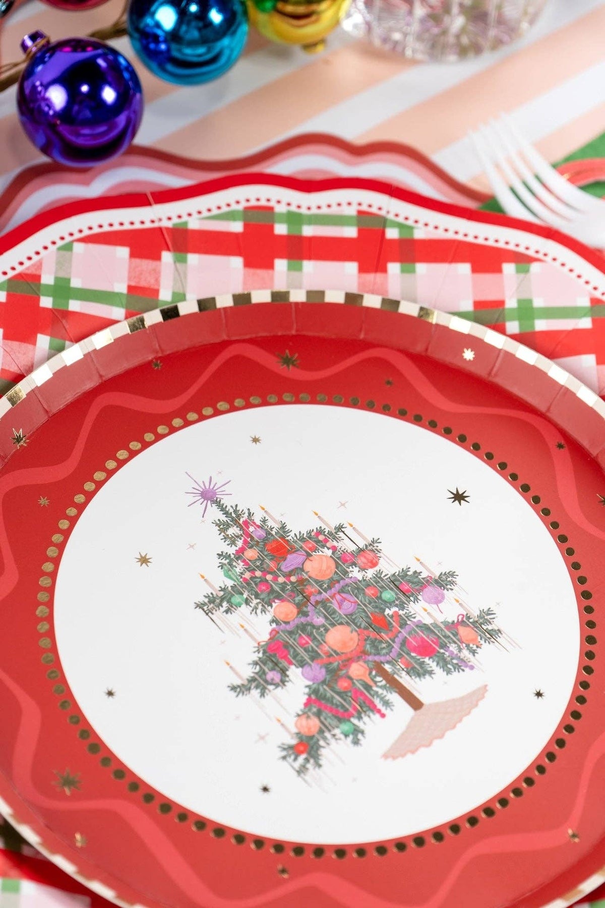 Close-up of the tree plate layered on a red scalloped plate and plaid dinner plate.