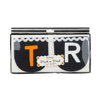 Front of retail packaging showing the felt banner folded inside a windowed black box. Two black felt pieces visible through the window — one with an orange "T" letter and one with a cream "R" letter. White rickrack ribbon visible along the top. Small pumpkin-bordered label reads "My Mind's Eye / Trick or Treat / Felt Banner."
