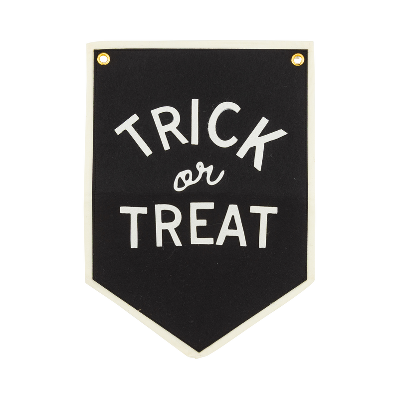 Trick or Treat Halloween felt banner in black with cream felt lettering, cream canvas border and brass grommets