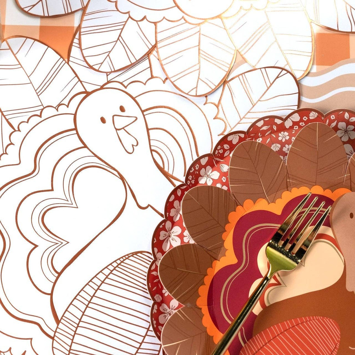 Angled view of the turkey coloring placemat showing the copper-foil outline and partially colored feathers.