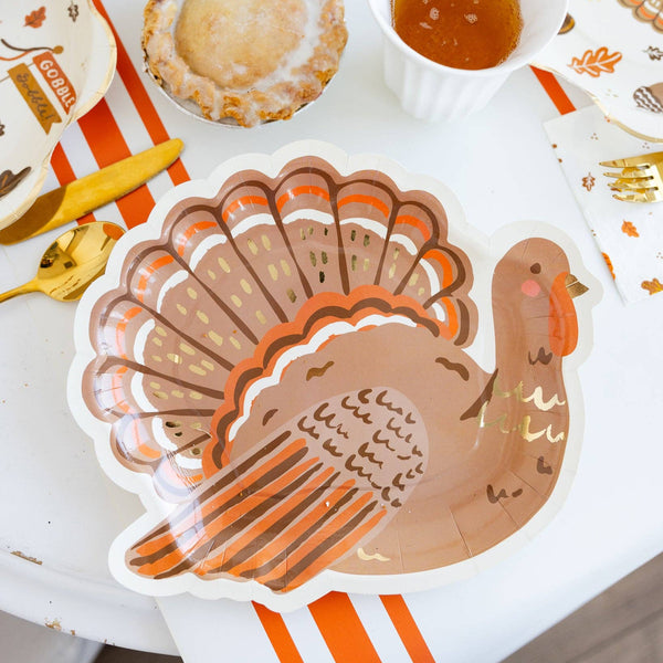 Angled view of turkey-shaped plate showing curved silhouette and rim.