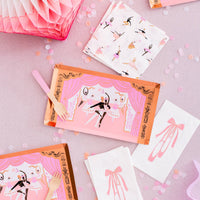 Video display showing tutu-shaped paper plates, striped gold cups, and ballerina guest napkins for a "Tutu Cute" party.
