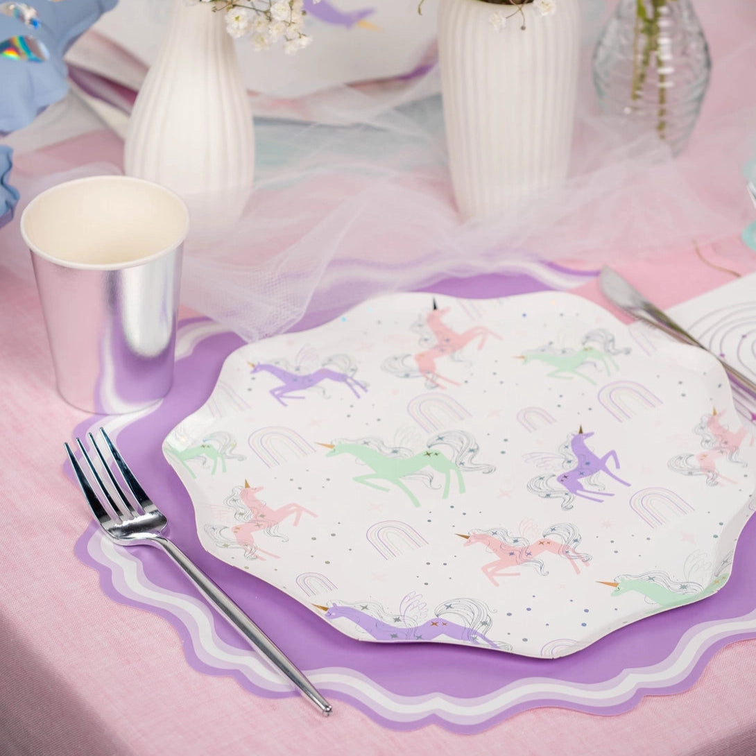 Tablescape: unicorn dinner plate layered over lilac charger with roses and tulle.