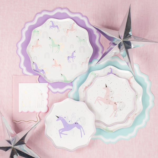 flat lay of dinner + dessert unicorn plates stacked in pastels.