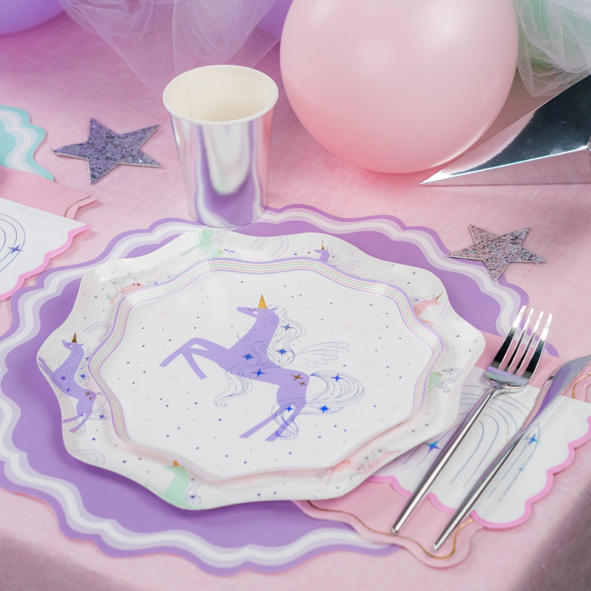 Lavender unicorn plate with silver cup and rainbow napkin—easy unicorn party napkins styling.