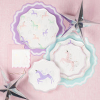 Flat lay: stacked dinner + dessert unicorn plates with silver stars.