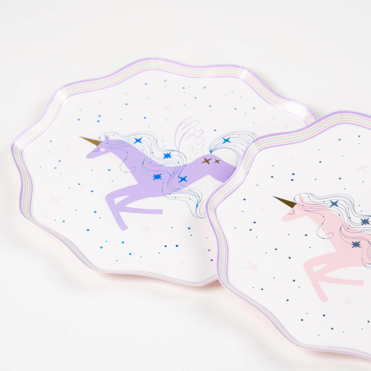Close detail of foil sparkle and pastel rainbow rim on unicorn dessert plate.