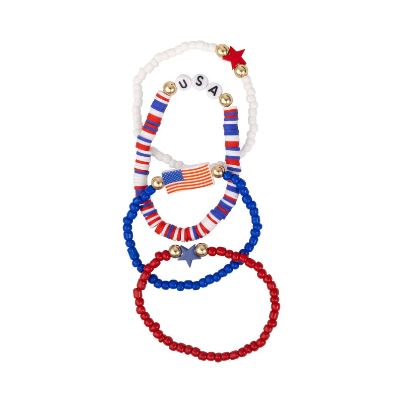 Flat lay of four patriotic beaded bracelets arranged overlapping on a white background showing USA letter beads, flag charm, and star details