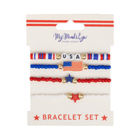 Front of packaging for patriotic bracelet set by My Mind's Eye showing four beaded bracelets with USA letters, flag charm, and star details on branded gift card