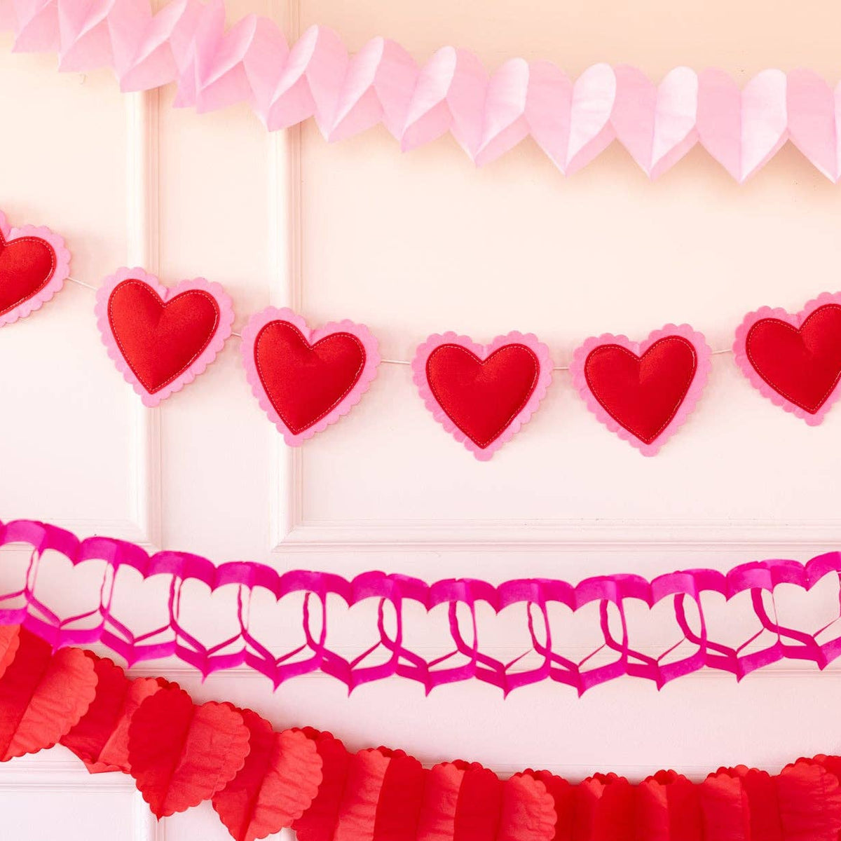 Close-up of pink and red heart tissue garlands