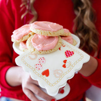 valentines charm napkin holding pink frosted cookies