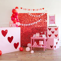 Playing card paper banner styled for a Valentine’s Day party backdrop